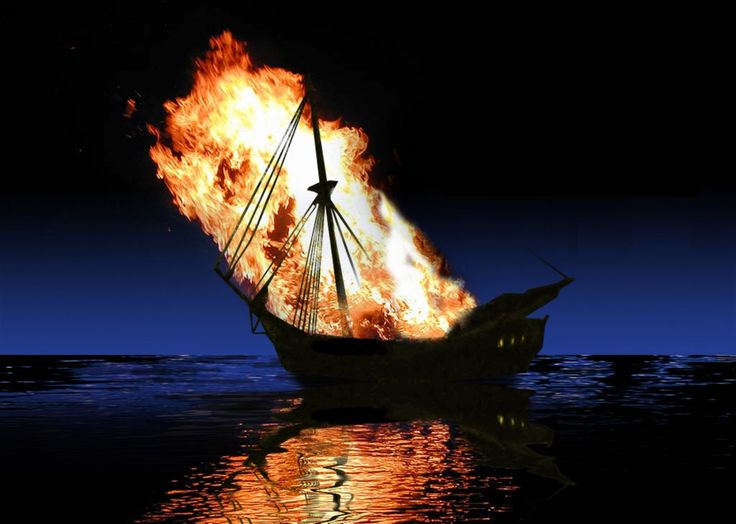 a boat is on fire in the ocean at night with it's sails blazing