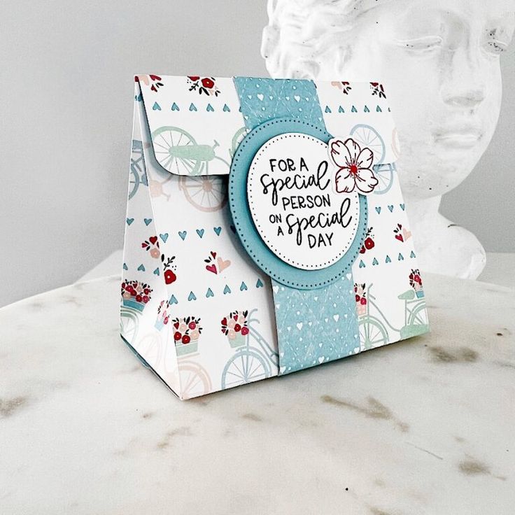 a white marble table topped with a paper bag and a busturine behind it