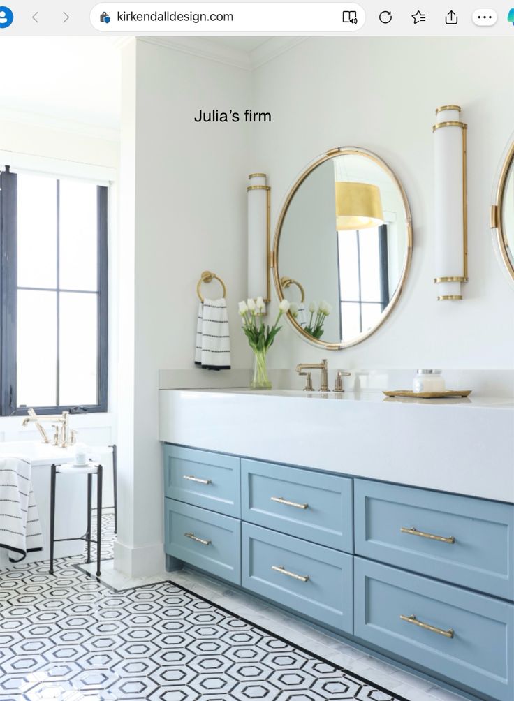 a bathroom with two sinks and mirrors on the wall