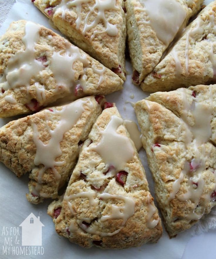 scones with icing sitting on top of a white plate