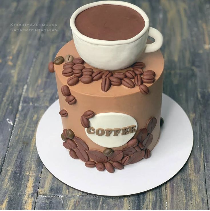 there is a cake that has coffee on the top and beans around it as well