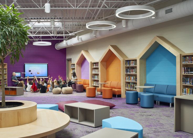 the children's library is brightly decorated with colorful bookshelves and seating areas