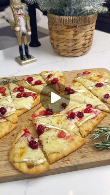 a wooden cutting board topped with slices of pizza