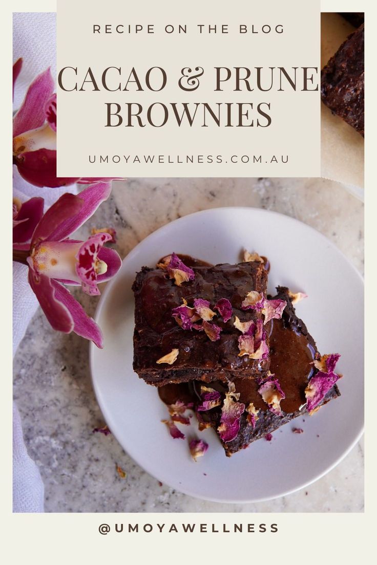 a white plate topped with brownies on top of a marble counter next to pink flowers