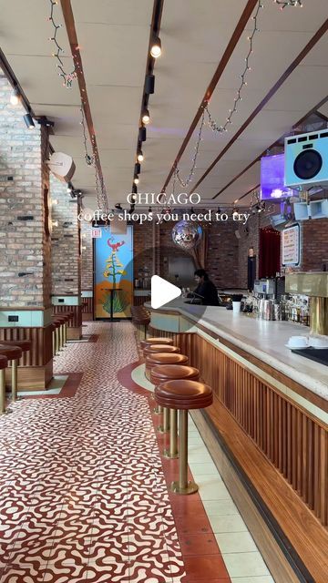 the inside of a restaurant with wooden bar stools and tile flooring on the walls