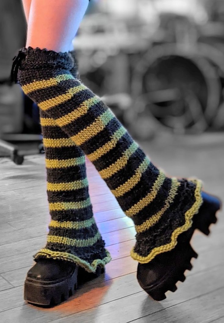 a woman's legs wearing black and yellow striped socks