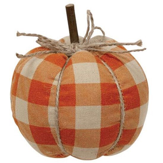 an orange and white checkered pumpkin sitting on top of a wooden stick with twine