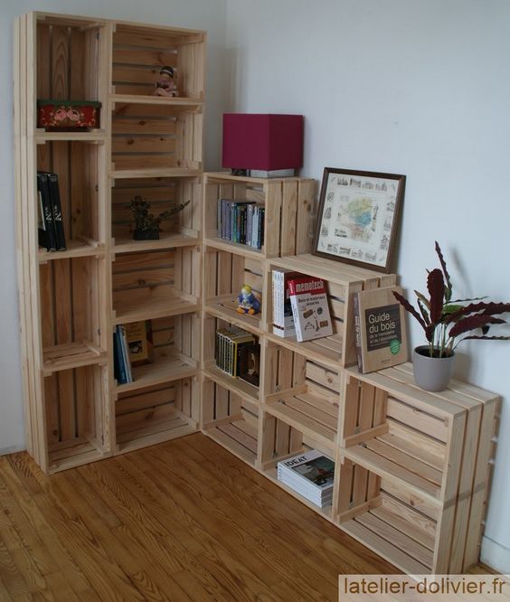 a wooden book shelf filled with lots of books next to a wall mounted planter