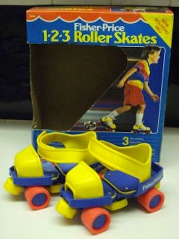 three plastic roller skates in front of a box