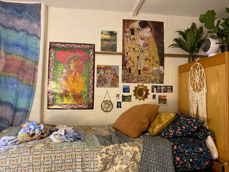 a bedroom with many pictures on the wall and bed in front of an unmade bed