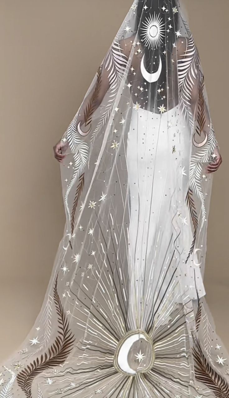 a glass figurine with a veil and stars on it