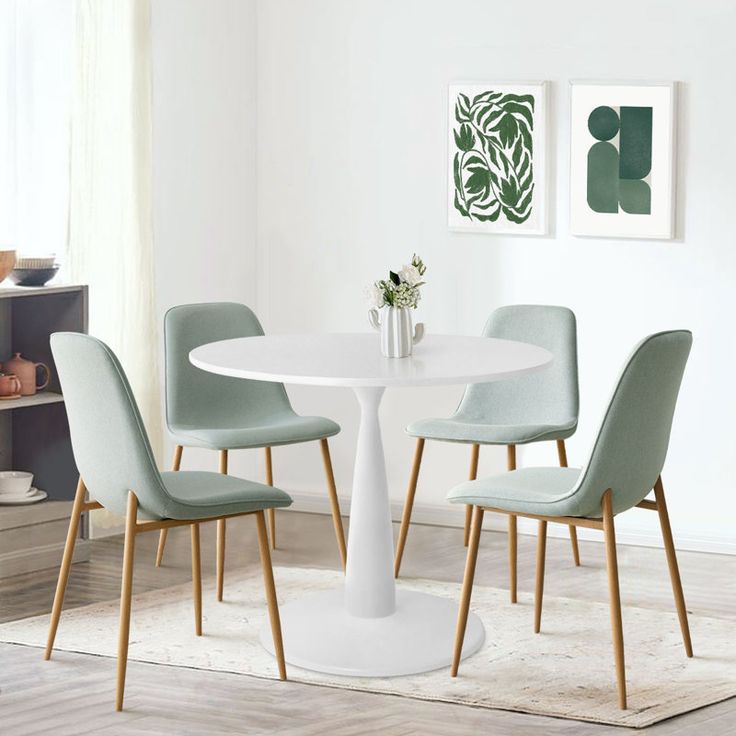 a white table with four chairs around it