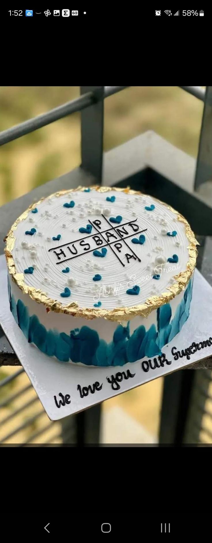 a cake that is sitting on top of a paper towel in front of a fence