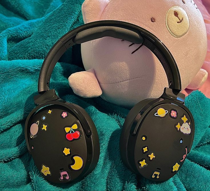 a stuffed animal and headphones on a blanket