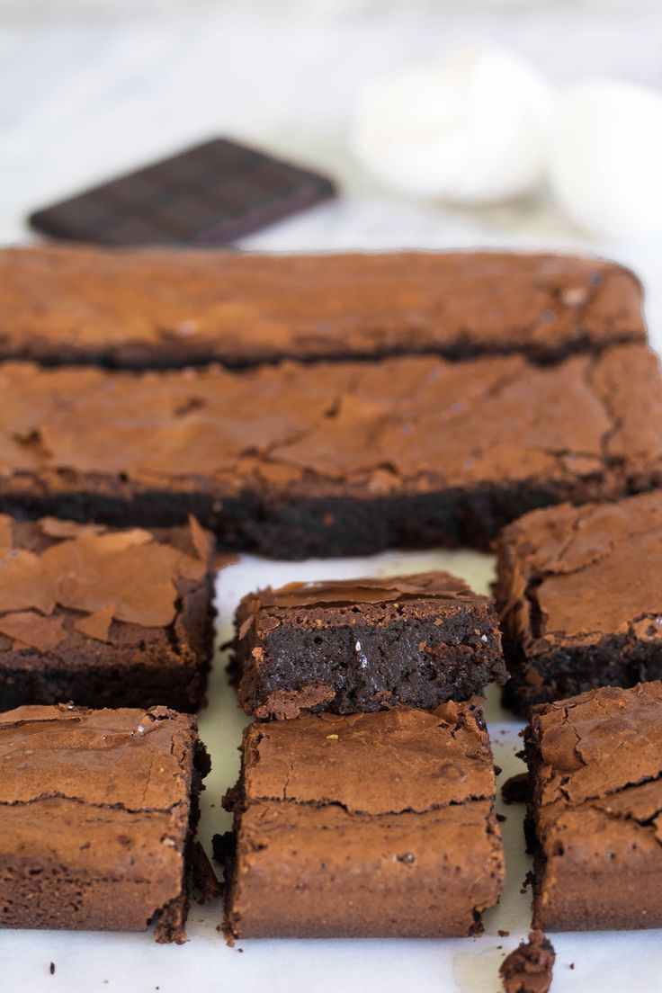 chocolate brownies cut into squares on a white plate