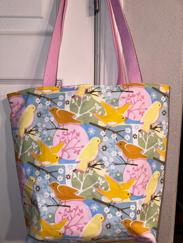 This is a cute tote bag I made with this sweet birdie fabric. It is fully lined with an inner pocket.  Measures approx 13" down the side seam. Opening is approx 15" laying flat (side seam to side seam). There is a 4" gusset on the bottom. Pink webbing for straps.   Machine washable gentle cycle. Cute Tote Diaper Bag For Daily Use, Cute Daily Use Tote Diaper Bag, Spring School Bags In Fabric, Spring School Fabric Bags, Reversible Tote Shoulder Bag For School, Reversible Fabric Tote Bag, Yellow Fabric Tote Bags, Cute Everyday Bag With Pockets, Cute Everyday Shoulder Bag With Softback