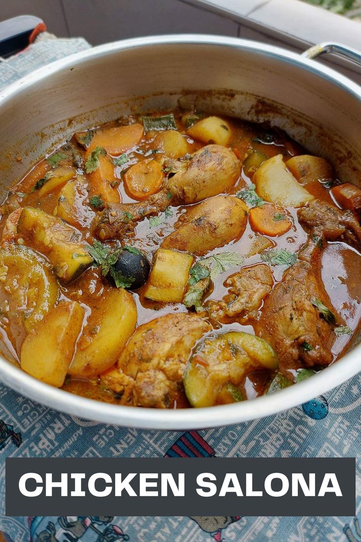 a bowl filled with chicken and potatoes on top of a table