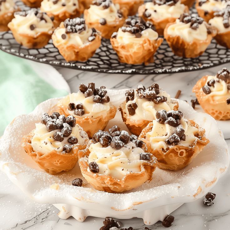 there are many cupcakes on the plate and one is filled with chocolate chips