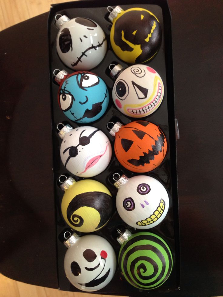 an assortment of halloween ornaments in a black box