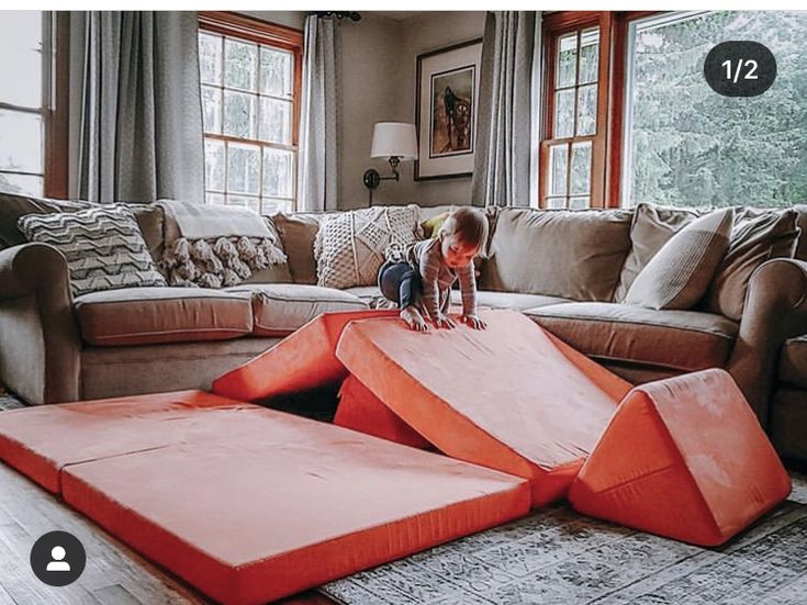 a small child playing on an inflatable dog bed at the end of a living room