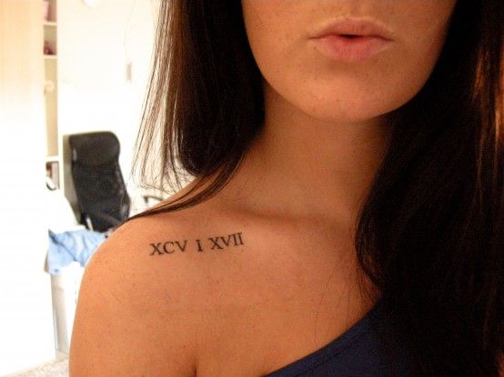 a woman with a roman numeral tattoo on her shoulder