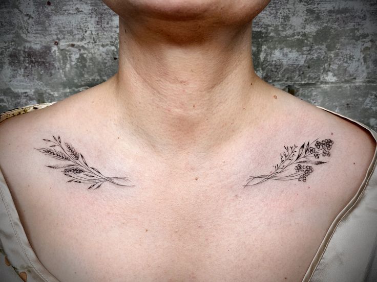 a woman's chest with flowers and leaves tattooed on her left side ribcage