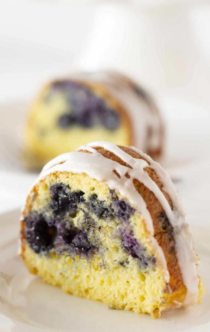 a piece of blueberry bundt cake on a plate with a bite taken out