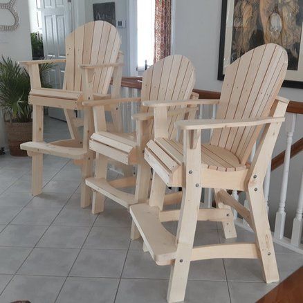 three wooden chairs sitting on top of a tiled floor