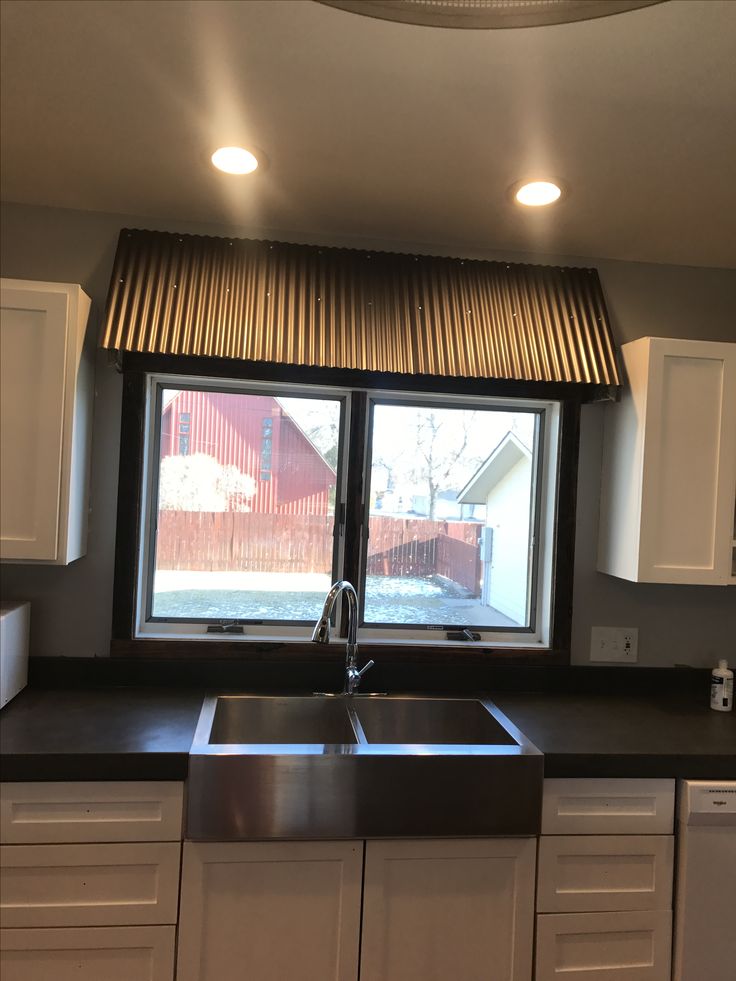 a kitchen with a sink and window in it