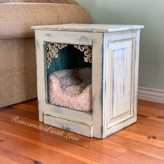 a dog bed in a wooden crate on the floor