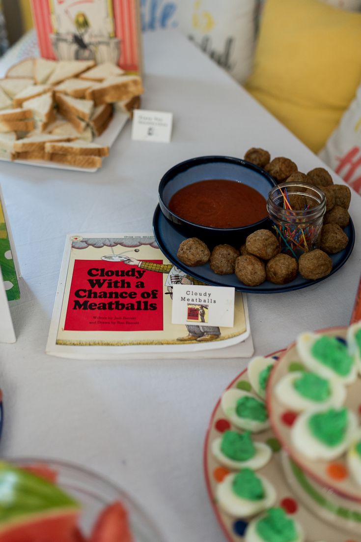 a table topped with plates and bowls filled with food