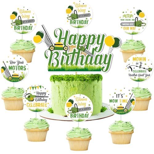 a green birthday cake surrounded by cupcakes with happy birthday signs on them and decorations