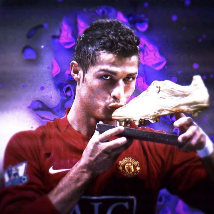 a man holding a soccer shoe in front of his face