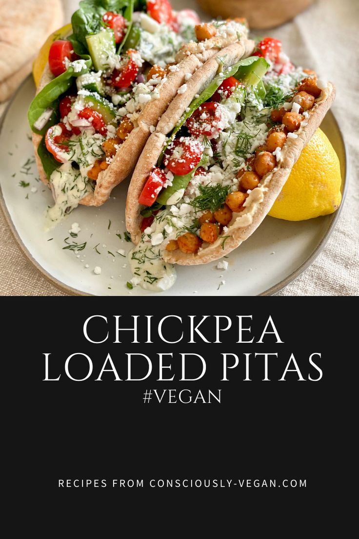 two tacos are sitting on a plate next to some lemons and bread with the title chickpea loaded pitas vegan