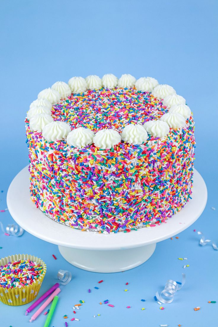 a birthday cake with sprinkles and white frosting