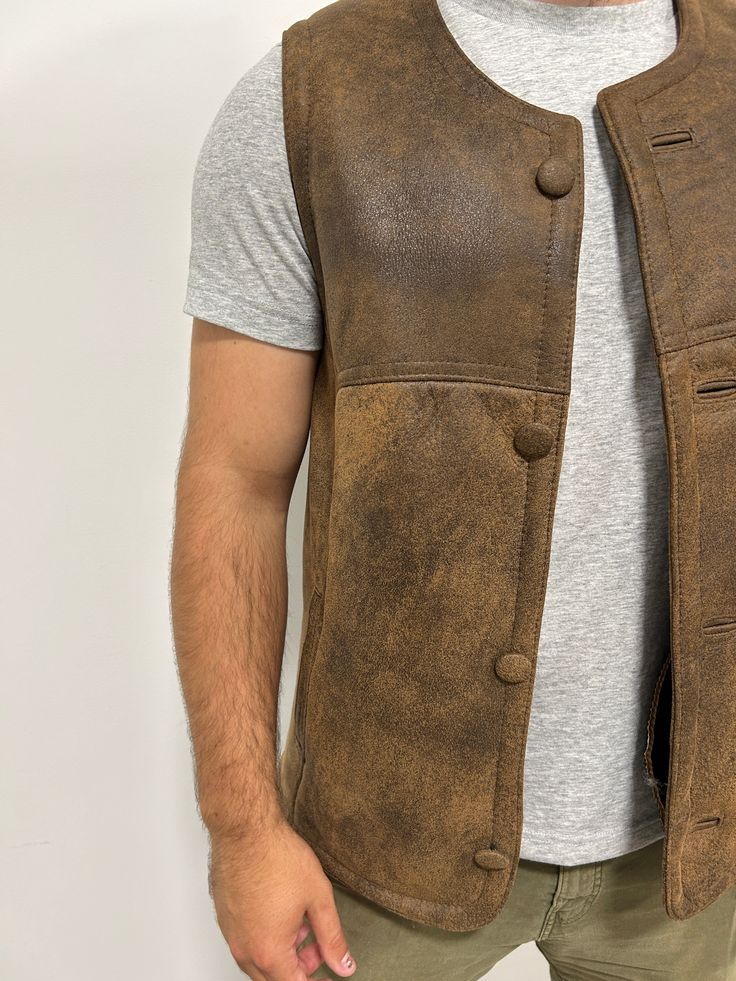 Perfect for three seasons, with the choice to layer on cooler days. Our sheepskin vest are durable, stylish and 100% natural allowing for your body to regulate warm in a productive way. Do you hate how body heat feels from polyester or synthetic fabrics? Then natural sheepskin and wool is the right choice for you. Our rancher vest is made from 100% leather and lined with 100% black mutton sheepskin. Our first model is wearing a size Large, is 6’ 5” and 175 pounds Our second model is wearing a si Leather Winter Outdoor Vest, Rugged Brown Winter Vest, Brown Rugged Vest For Winter, Brown Rugged Winter Vest, Fitted Sleeveless Rugged Outerwear, Rugged Leather Vest Outerwear, Rugged Fitted Vest Outerwear, Rugged Brown Vest Outerwear, Fitted Leather Vest For Outdoor