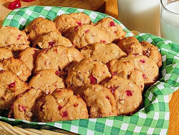 a basket filled with cookies next to a glass of milk