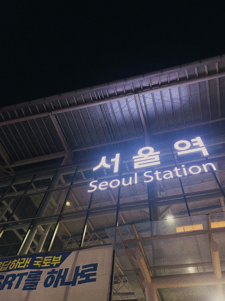 the seoul station sign is lit up at night