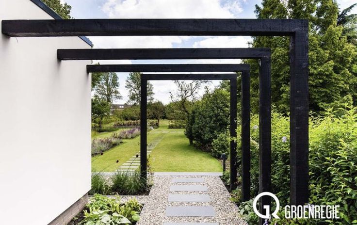 an outdoor garden area with stone walkways and graveled path leading to the front door