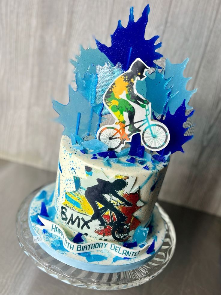 a birthday cake with an image of a bicycle rider on it