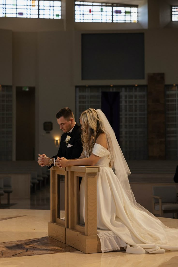 the bride and groom are sitting at the alter