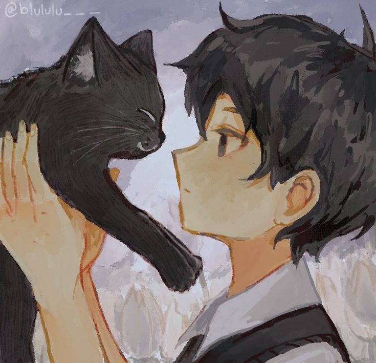 a boy holding a black cat in his hand and looking at it's face