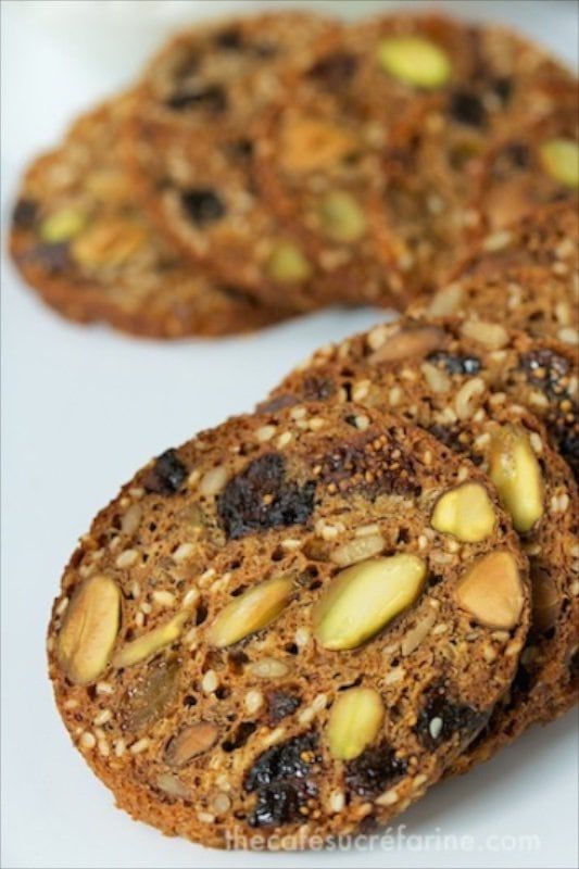 three cookies with nuts and raisins on top