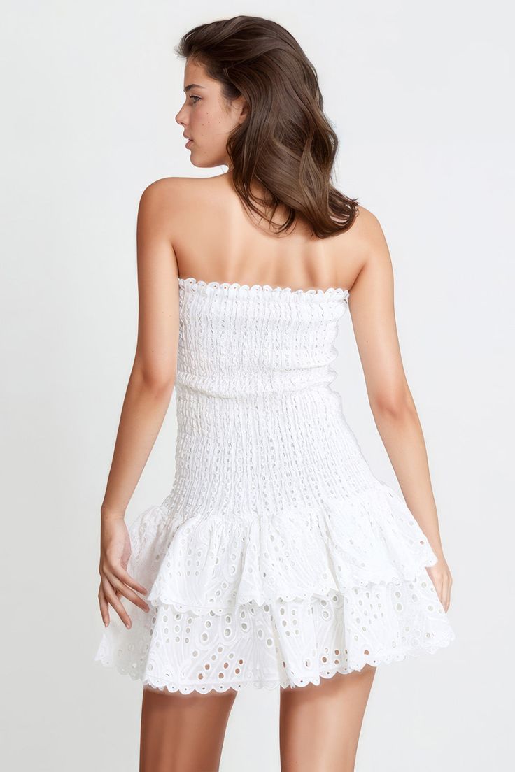 Look charming in this elastic, sleeveless mini dress. Its intricate embroidery, strapless silhouette, and playful ruffles make it perfect for special occasions. With its stretchy fabric, it promises a comfortable and flattering fit.Fabric: Cotton, Polyester Feminine Strapless Ruched Mini Dress, White Stretch Bandeau Mini Dress, White Strapless Mini Dress With Smocked Back, Bandeau Ruffle Summer Dress, Feminine Strapless Dress With Ruffles, Fitted Strapless Dress With Ruffled Skirt, Fitted Off-shoulder Dress With Ruffled Skirt, White Bandeau Strapless Dress With Ruffles, Spring Bandeau Dress With Ruffles