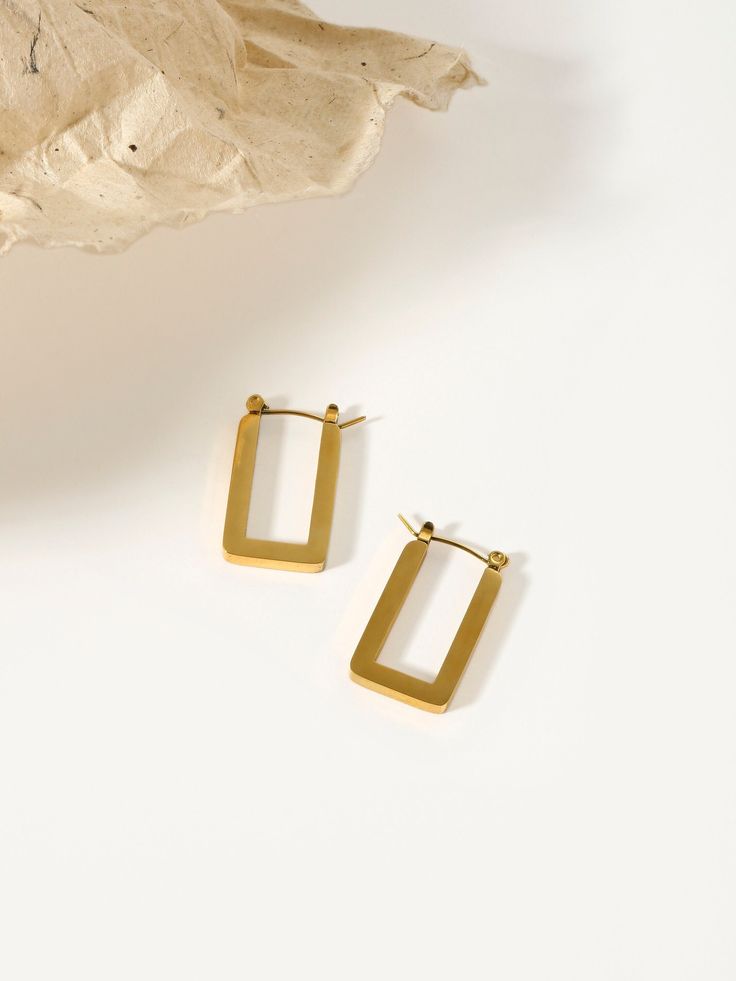 Step into sophistication with our U Shape Earrings, expertly crafted as chunky gold hoops in a unique rectangle design. These thick huggie earrings, enhanced with anti-tarnish properties, are the epitome of minimalist chic. Gold Rectangular Huggie Earrings, Gold Rectangular Minimalist Huggie Earrings, Classic Rectangular Huggie Earrings For Everyday, Modern Rectangular Huggie Earrings, Gold Rectangular Huggie Earrings For Everyday, Everyday Gold Rectangular Hoop Earrings, Rectangular Yellow Gold Hoop Earrings For Everyday, Minimalist Rectangular Huggie Earrings, Everyday Gold Square Huggie Earrings