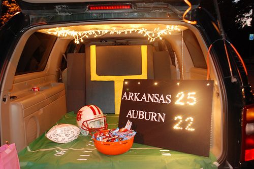 the back end of an suv with footballs and other sports memorabilia on it's trunk