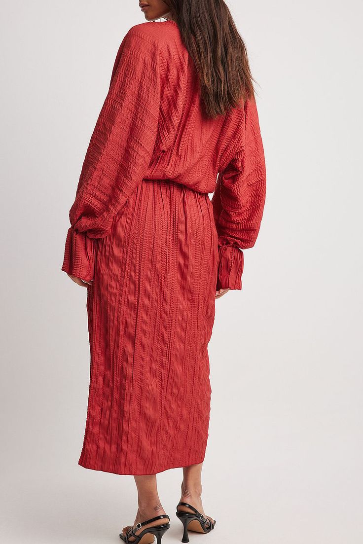 This midi dress features a relaxed flowy fit, a structured material and pleated draped details. It has a deep v neckline and extra wide sleeves with flared, gathered cuffs. V-neck Midi Dress With Folds For Work, Chic V-neck Midi Dress With Folds, Red Midi Dress With Gathered Sleeves, V-neck Maxi Dress With Elastic Sleeves For Daywear, Chic V-neck Dress With Crinkle Texture, Spring Long Sleeve Midi Dress With Folds, Billowy V-neck Maxi Dress With Gathered Sleeves, Chic Red Dress With Pleated Sleeves, Viscose Midi Dress With Gathered Sleeves