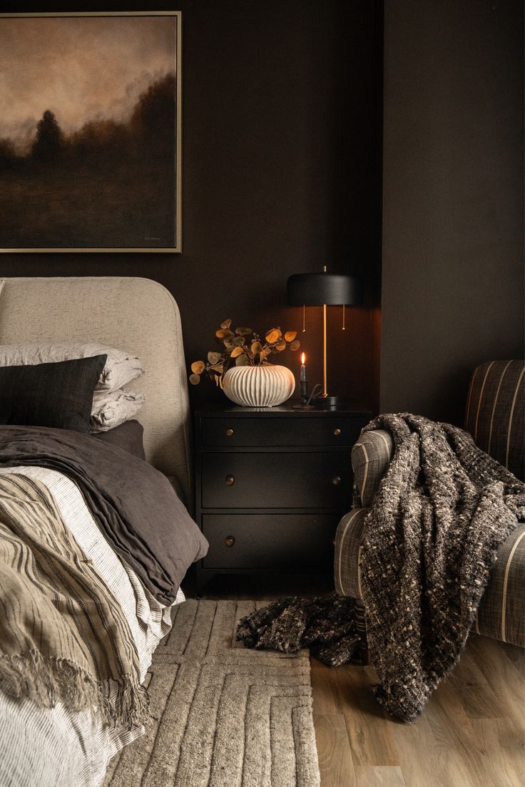 a bedroom with black walls and wooden floors