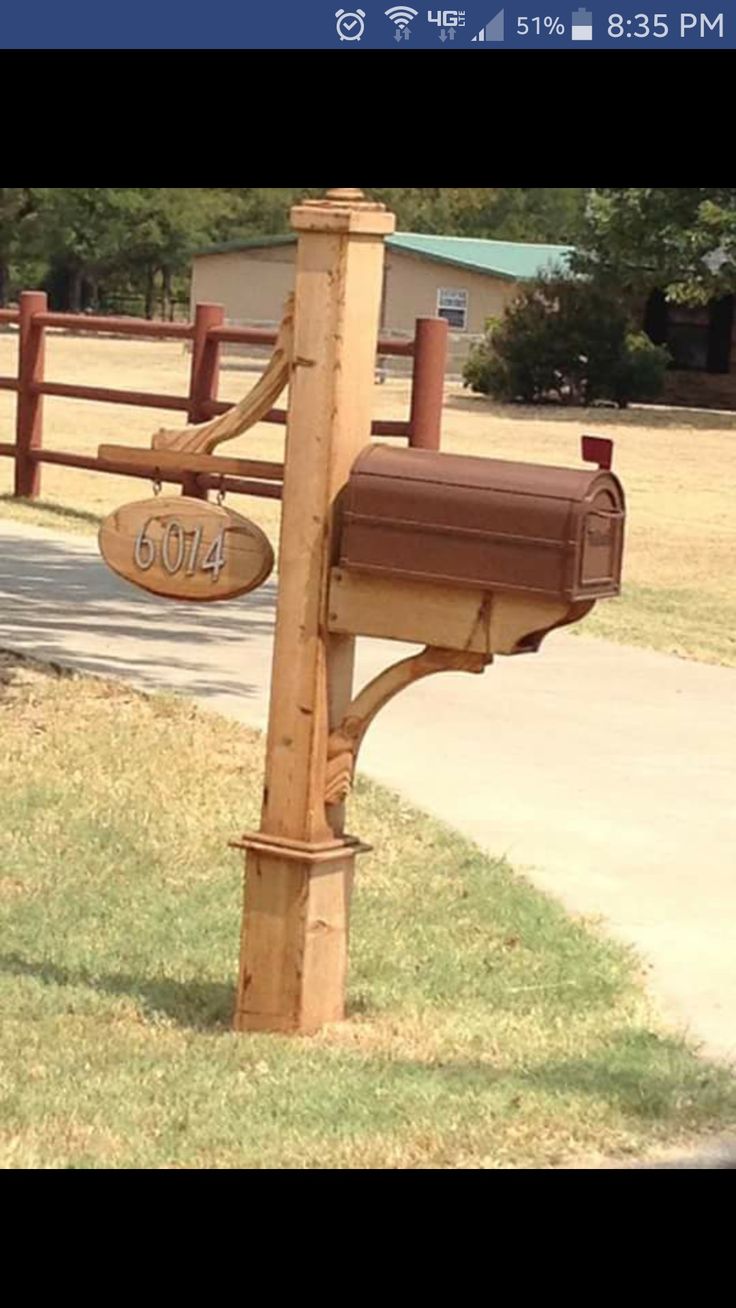 a mailbox attached to a wooden post