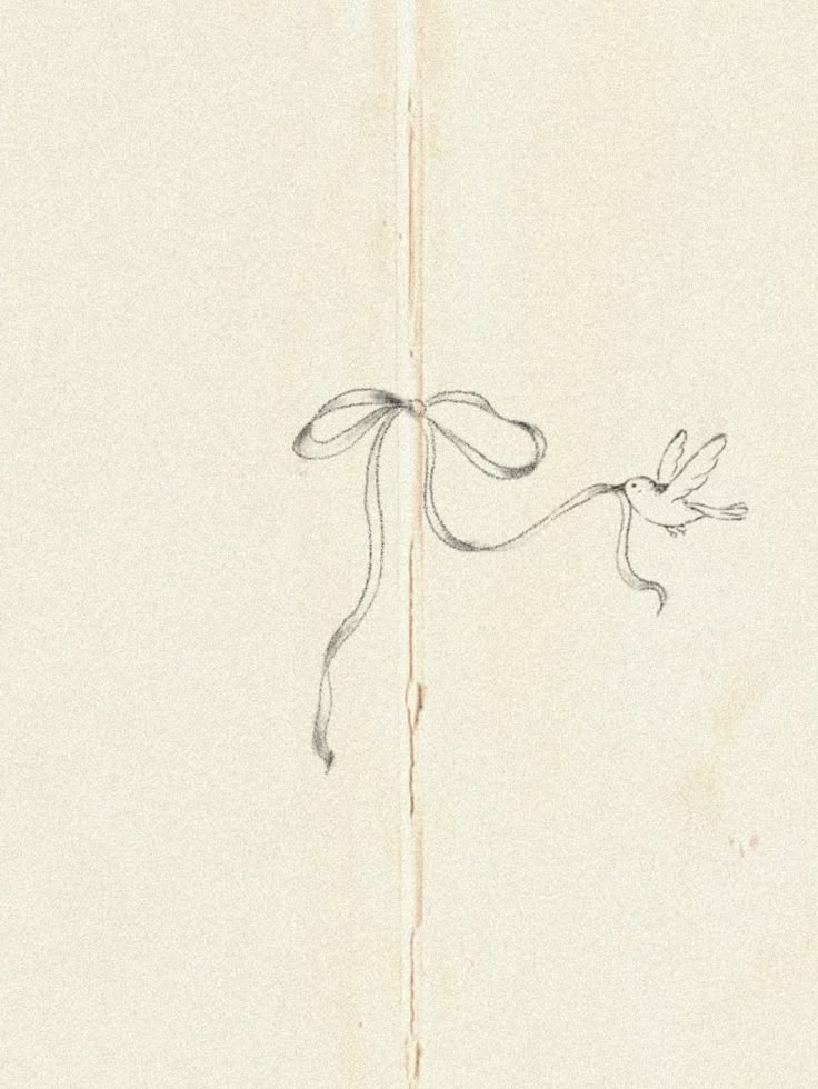 an old book with a drawing of a bird on it's side and a ribbon tied around the edge